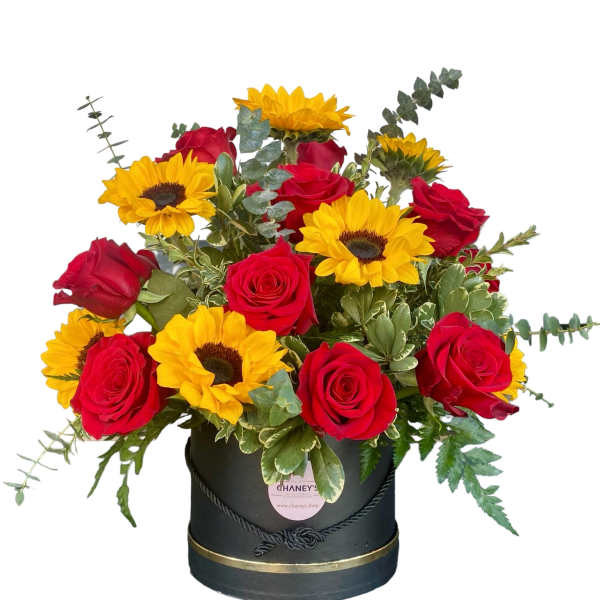 Red roses and yellow sunflowers in a black hatbox