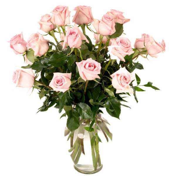 Tall arrangement of light pink roses in a clear glass vase with long stems