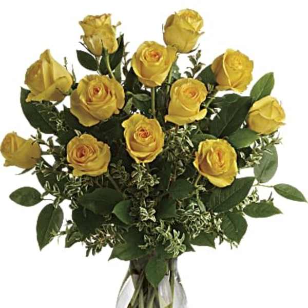 Yellow roses arranged in a clear glass vase