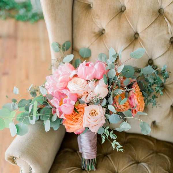 Pink and peach bouquet with eucalyptus on a chair