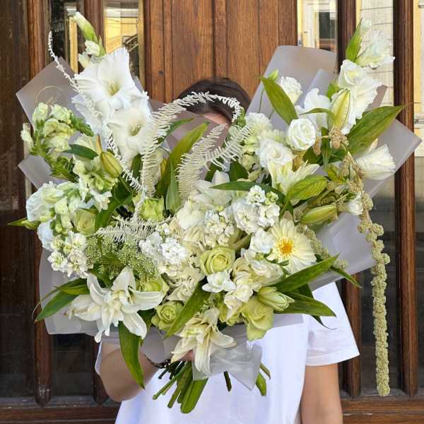 Large white bouquet with lilies, roses, and mixed blooms