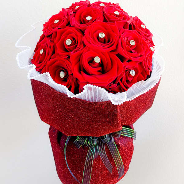 Red rose bouquet with rhinestone accents and glittery red wrap