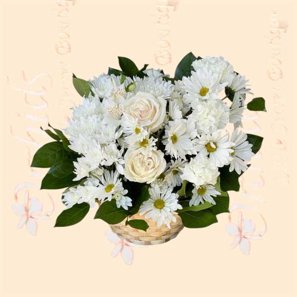 White flowers arranged in a woven basket with green leaves