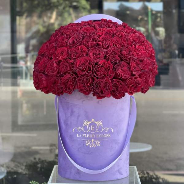Large dome of red roses in a lavender hatbox