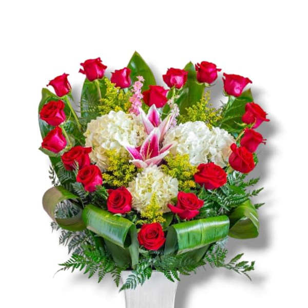 Red roses and white hydrangeas in a white vase