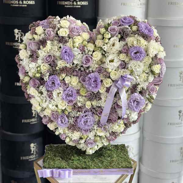 Heart-shaped floral arrangement in lavender, white, and cream tones