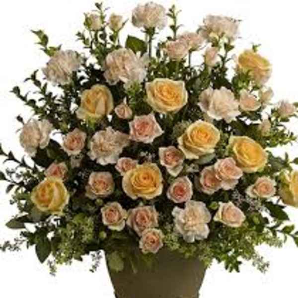 Arrangement of pale yellow and blush roses in a vase