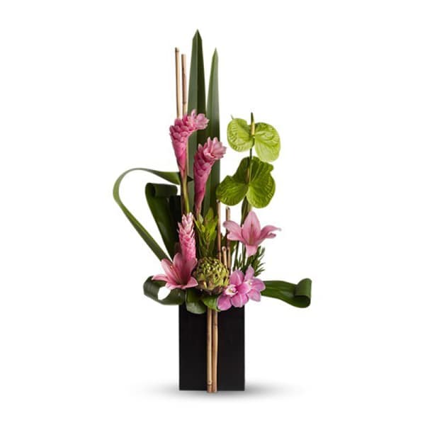 Tall tropical arrangement with pink flowers in a black vase