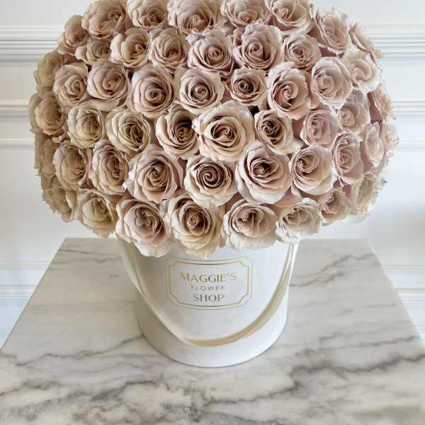 Large bouquet of blush roses in a white hat box with a ribbon bow
