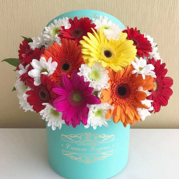 Colorful gerbera daisy bouquet in a turquoise hat box