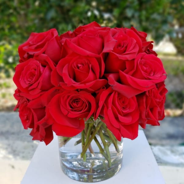 Red rose bouquet in a clear glass vase