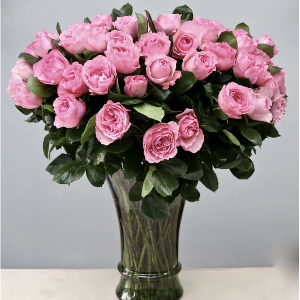 Pink roses arranged in a clear glass vase