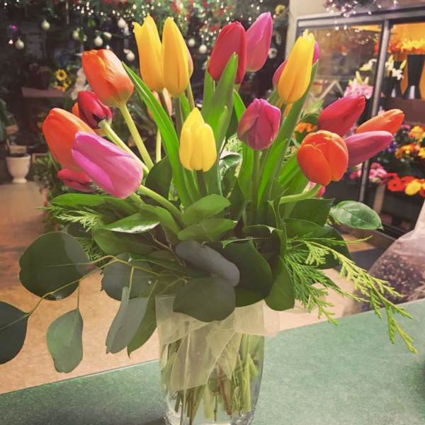 Bouquet of multicolored tulips in a clear glass vase