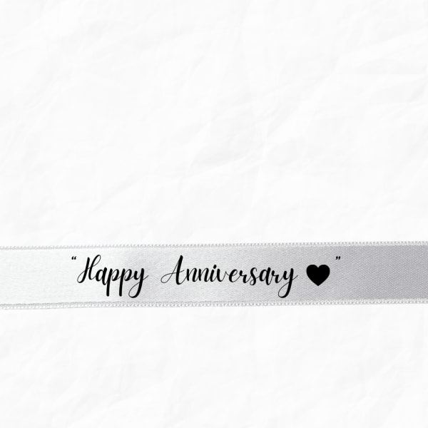White ribbon with "Happy Anniversary" text and a heart