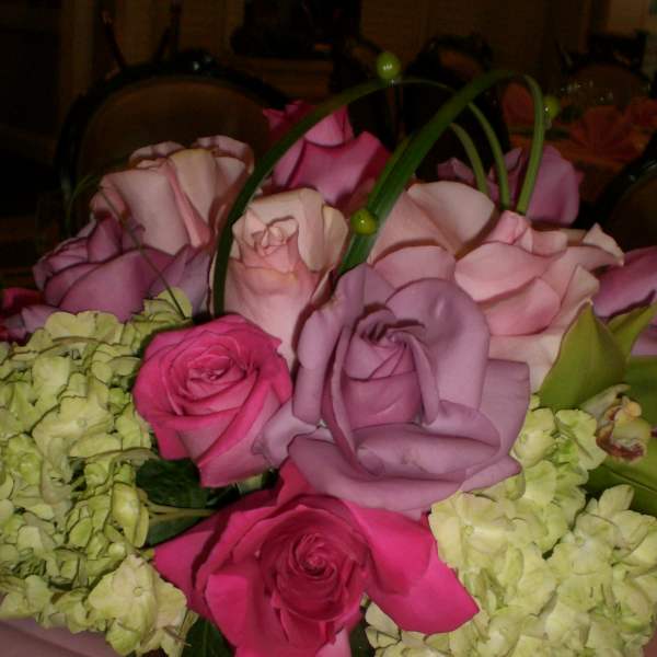 Pink and lavender roses with pale green hydrangeas in a square vase