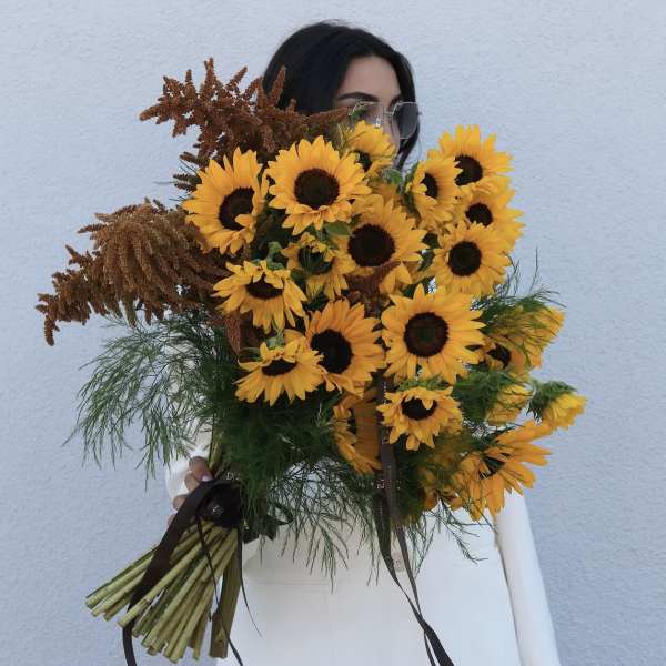 Bouquet of yellow sunflowers with brown filler flowers