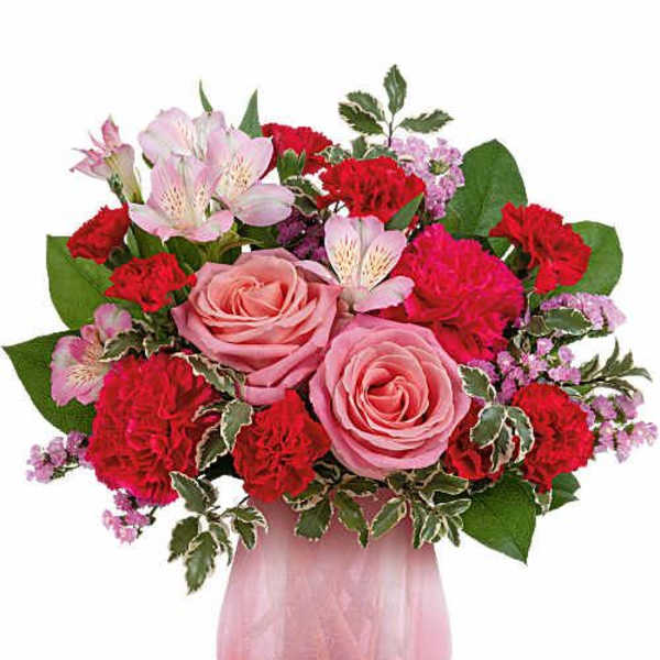 Pink and red mixed bouquet in a pink glass vase