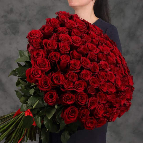 Large bouquet of red roses held by a person