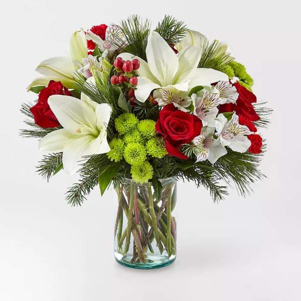 Bouquet of red roses and white lilies in a glass vase