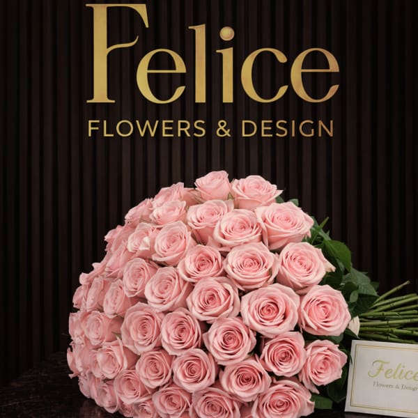 Large bouquet of pale pink roses on a dark surface