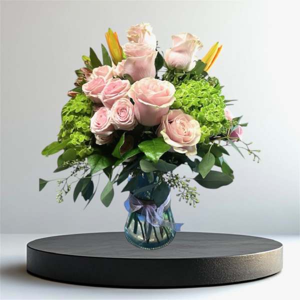 Pink roses and green hydrangeas in a glass vase