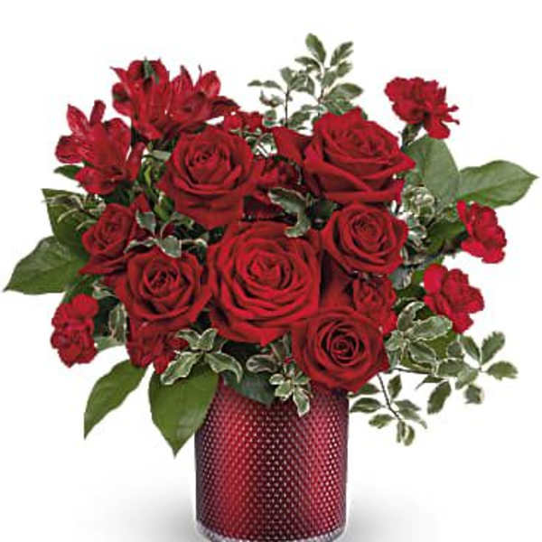 Red roses and red alstroemeria in a red vase