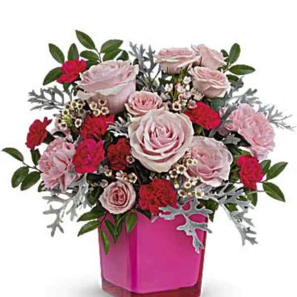 Pink and red rose bouquet in a magenta glass vase