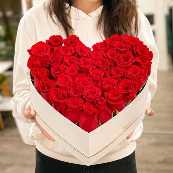 Heart-shaped box filled with red roses