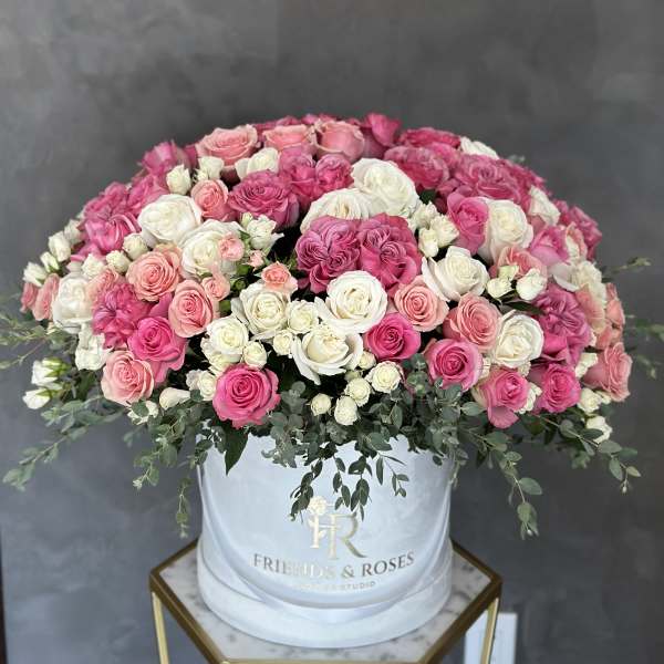 Large pink and white rose arrangement in a white hat box