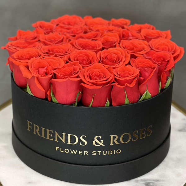 Round box filled with red roses