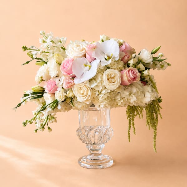 Pink and white floral arrangement in a clear glass vase