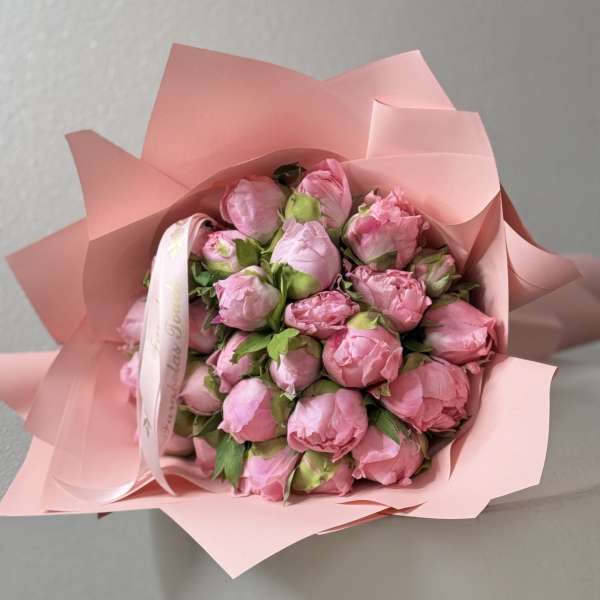 Bouquet of pink peonies wrapped in pink paper