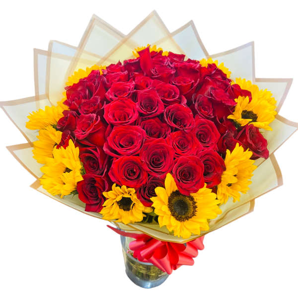 Bouquet of red roses and yellow sunflowers in a glass vase
