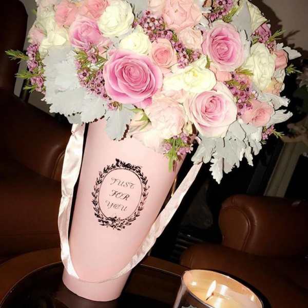 Pink and white rose bouquet in a pink cone wrap with ribbon