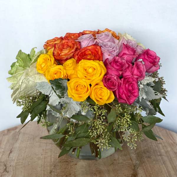 Bouquet of multicolored roses in a glass vase