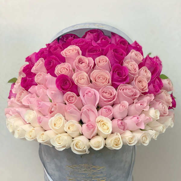 Round hatbox packed with ombre roses from fuchsia to blush pink to ivory