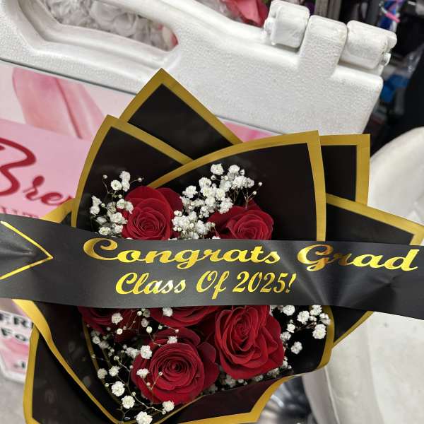 Bouquet of red roses with baby's breath and a graduation ribbon