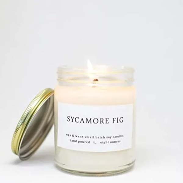 A scented candle in a glass jar with a metal lid