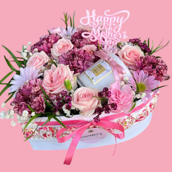 Pink floral gift box with roses, carnations, and a candle