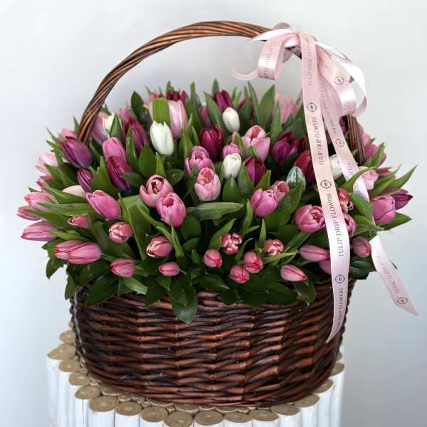 Basket of pink and white tulips with a pink ribbon bow