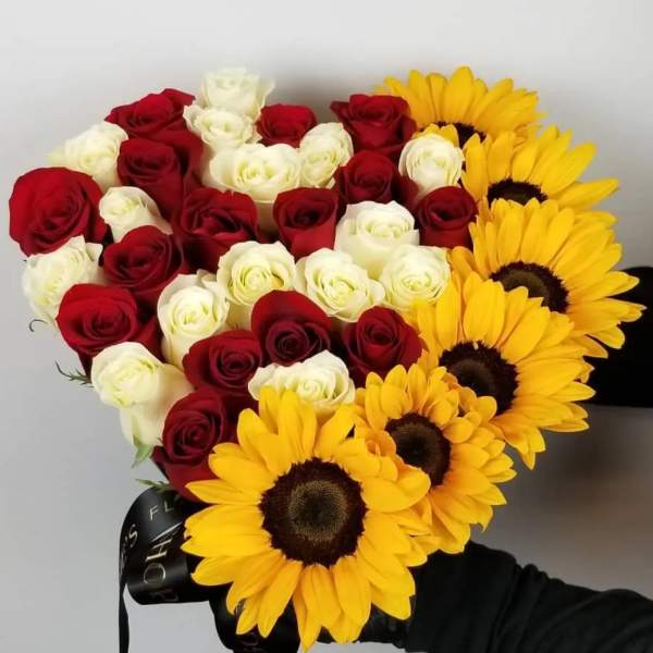 Heart-shaped bouquet of red and white roses with yellow sunflowers