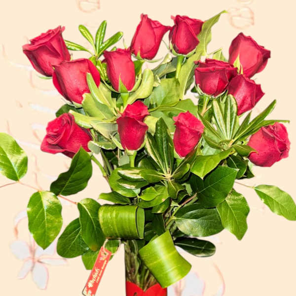 Bouquet of red roses in a glass vase with a heart tag