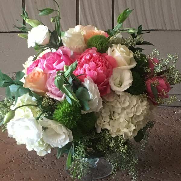 Mixed pink, white, and peach bouquet in a clear glass vase