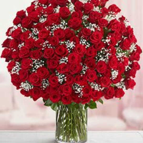 Large bouquet of red roses in a clear glass vase