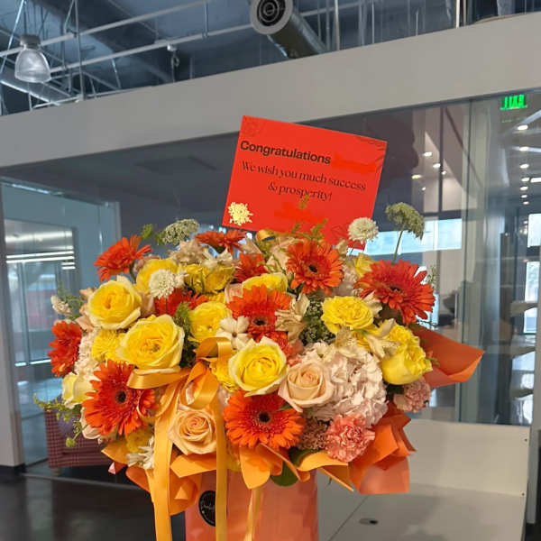 Orange and yellow bouquet with roses and gerbera daisies in a box