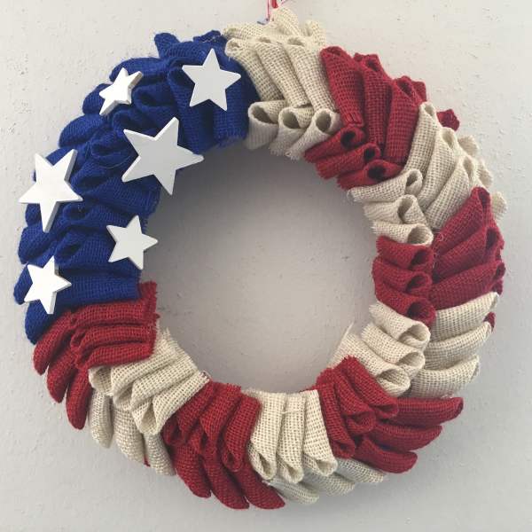 Patriotic wreath with red, white, and blue fabric folds and white stars