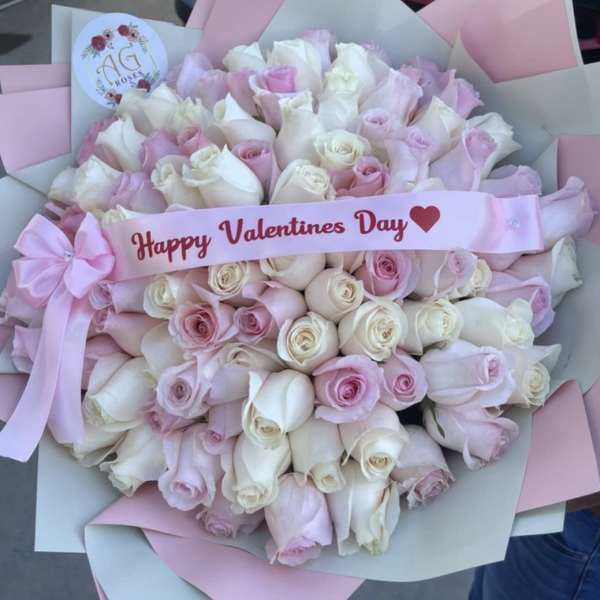Bouquet of pale pink and white roses with a Valentine's Day ribbon