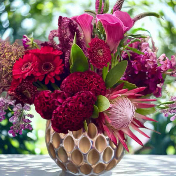 Pink and magenta mixed bouquet in a textured vase