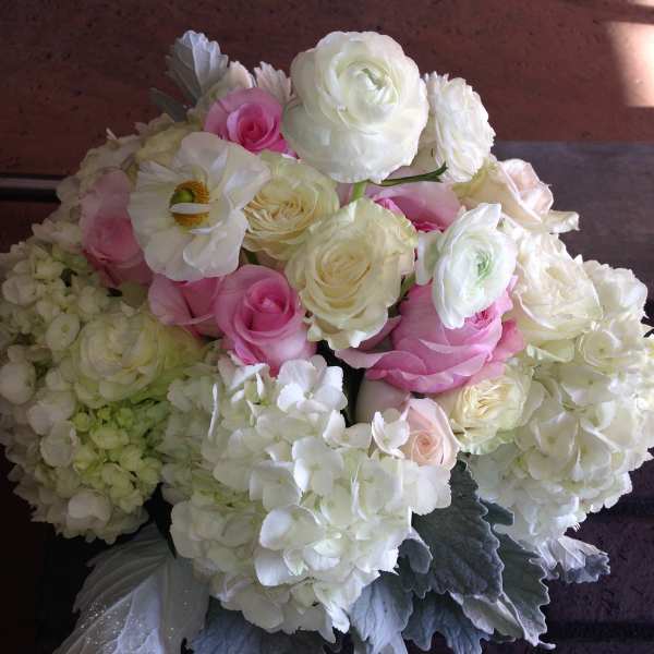 Bouquet of white and pink roses with hydrangeas and a white anemone