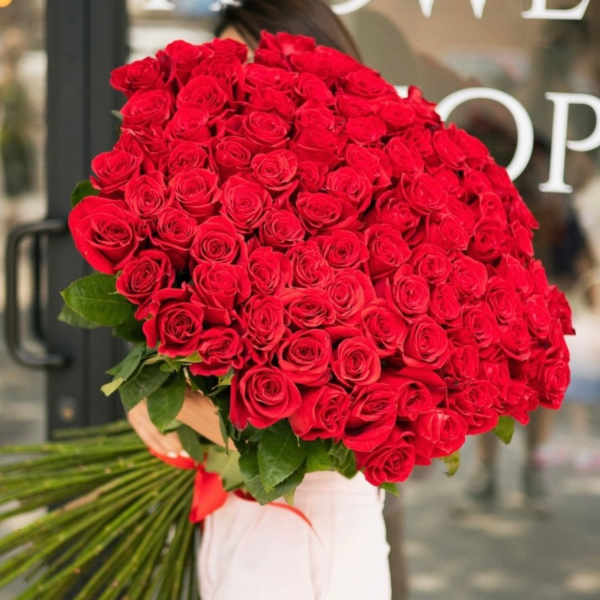 Large bouquet of red roses wrapped in paper